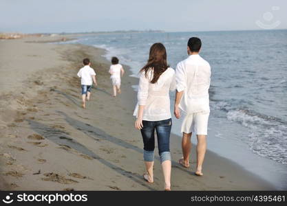 happy young family have fun and live healthy lifestyle on beach