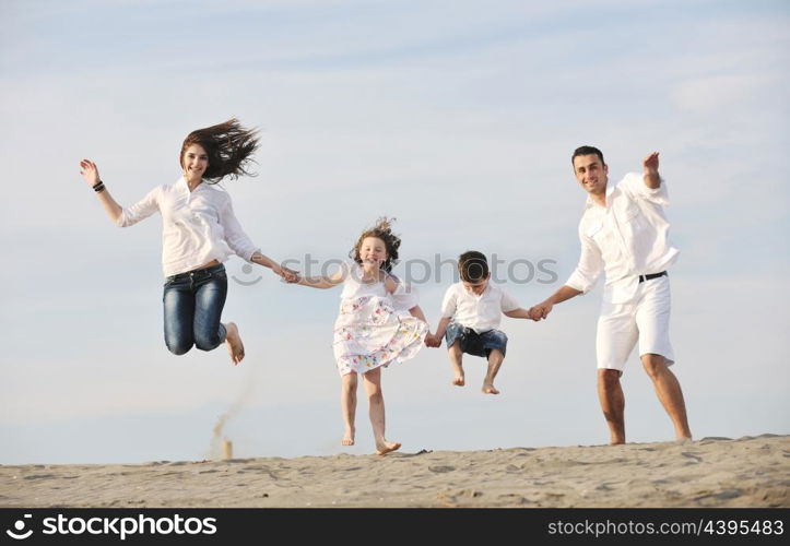 happy young family have fun and live healthy lifestyle on beach