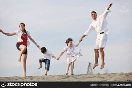 happy young family have fun and live healthy lifestyle on beach