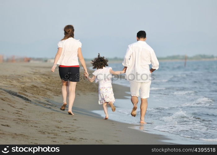 happy young family have fun and live healthy lifestyle on beach