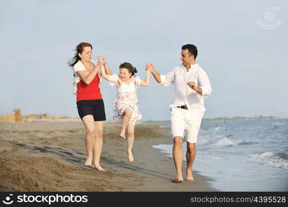 happy young family have fun and live healthy lifestyle on beach