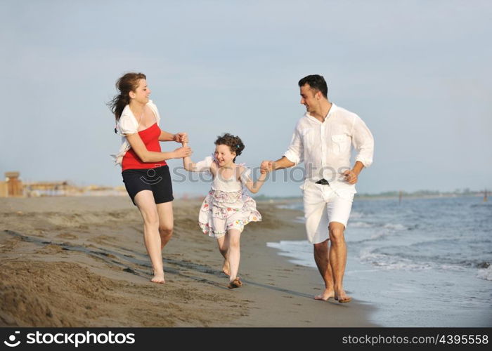 happy young family have fun and live healthy lifestyle on beach