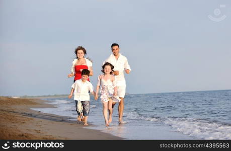 happy young family have fun and live healthy lifestyle on beach