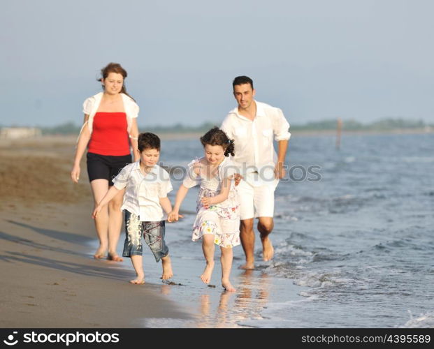 happy young family have fun and live healthy lifestyle on beach