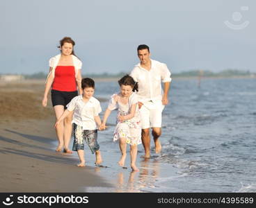 happy young family have fun and live healthy lifestyle on beach