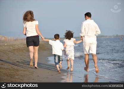 happy young family have fun and live healthy lifestyle on beach