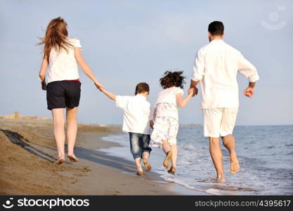 happy young family have fun and live healthy lifestyle on beach