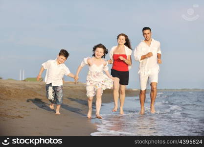 happy young family have fun and live healthy lifestyle on beach