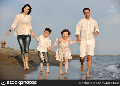 happy young family have fun and live healthy lifestyle on beach