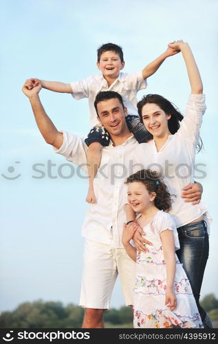 happy young family have fun and live healthy lifestyle on beach