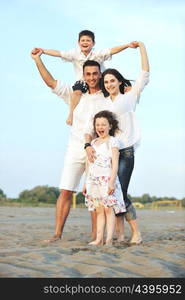 happy young family have fun and live healthy lifestyle on beach