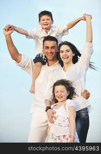 happy young family have fun and live healthy lifestyle on beach