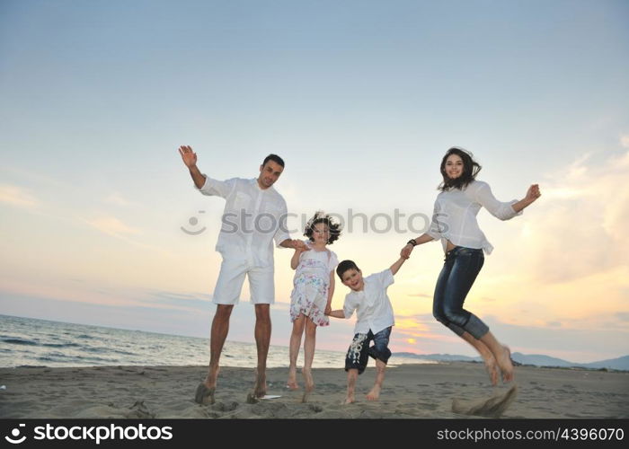 happy young family have fun and live healthy lifestyle on beach