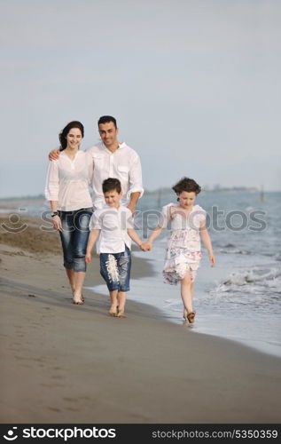 happy young family have fun and live healthy lifestyle on beach