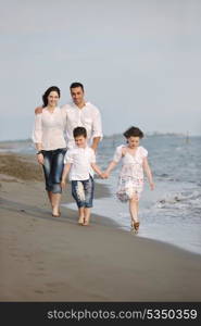 happy young family have fun and live healthy lifestyle on beach