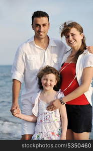 happy young family have fun and live healthy lifestyle on beach