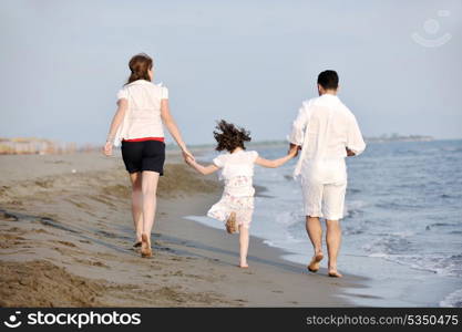 happy young family have fun and live healthy lifestyle on beach