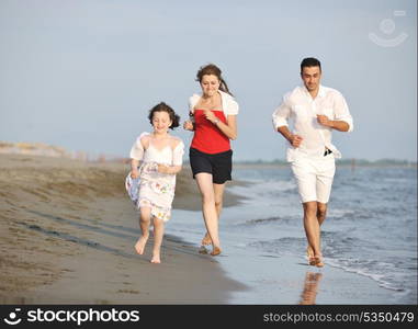 happy young family have fun and live healthy lifestyle on beach