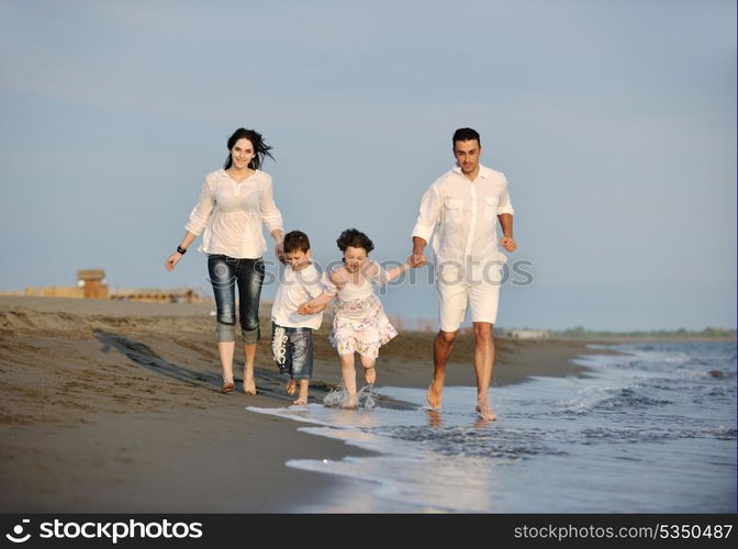 happy young family have fun and live healthy lifestyle on beach