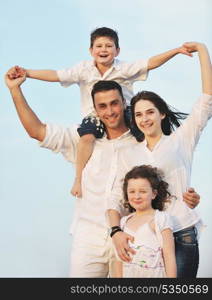 happy young family have fun and live healthy lifestyle on beach