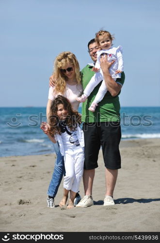 happy young family have fun and live healthy lifestyle on beach