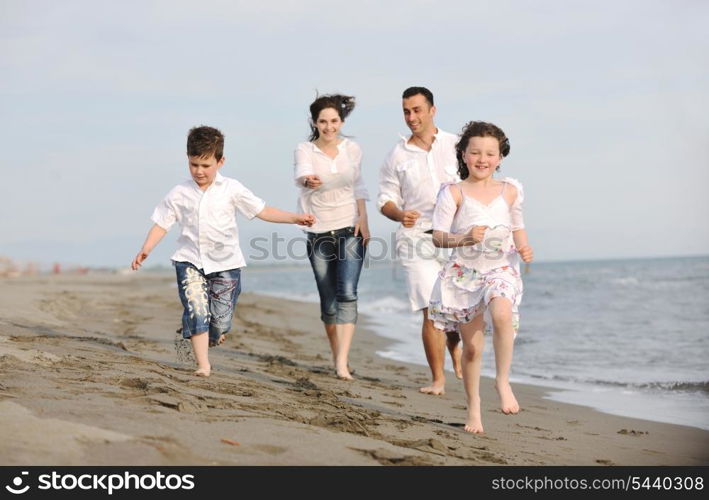 happy young family have fun and live healthy lifestyle on beach