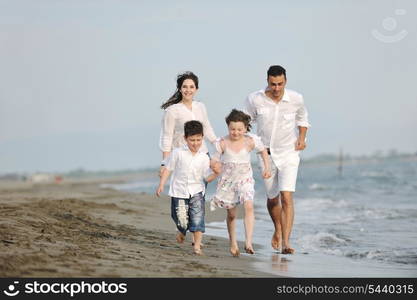 happy young family have fun and live healthy lifestyle on beach