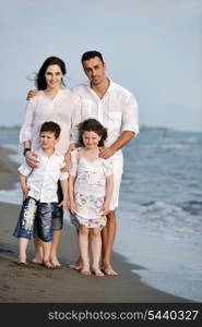 happy young family have fun and live healthy lifestyle on beach