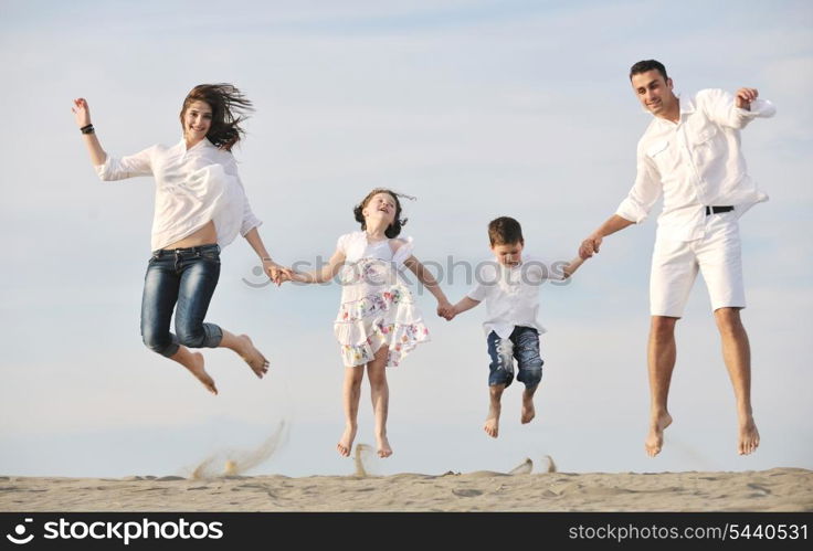 happy young family have fun and live healthy lifestyle on beach