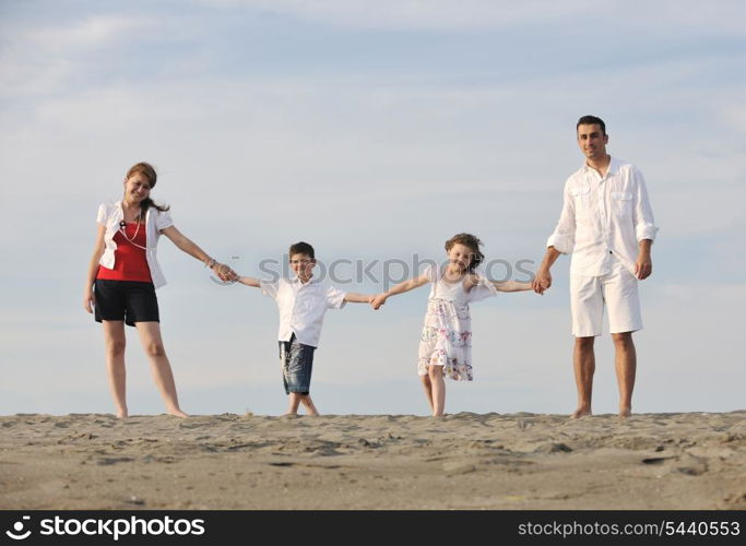 happy young family have fun and live healthy lifestyle on beach