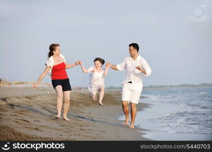 happy young family have fun and live healthy lifestyle on beach