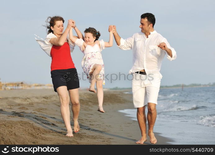 happy young family have fun and live healthy lifestyle on beach