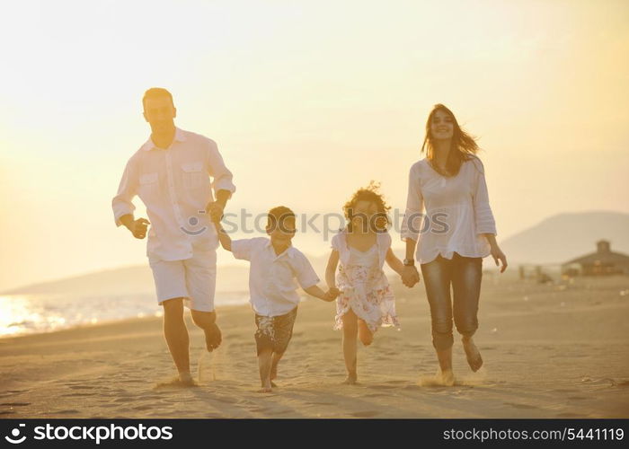 happy young family have fun and live healthy lifestyle on beach