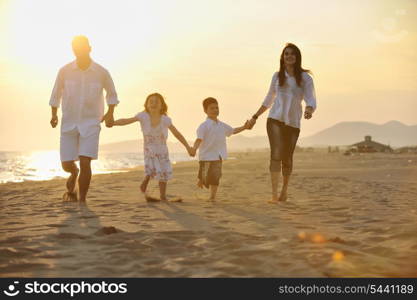 happy young family have fun and live healthy lifestyle on beach