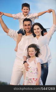 happy young family have fun and live healthy lifestyle on beach