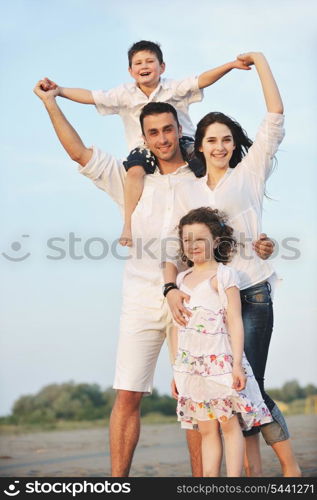 happy young family have fun and live healthy lifestyle on beach