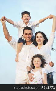 happy young family have fun and live healthy lifestyle on beach