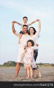 happy young family have fun and live healthy lifestyle on beach