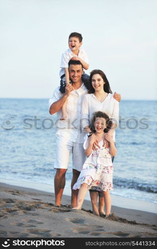 happy young family have fun and live healthy lifestyle on beach