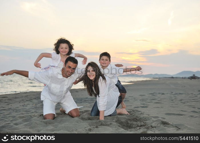 happy young family have fun and live healthy lifestyle on beach