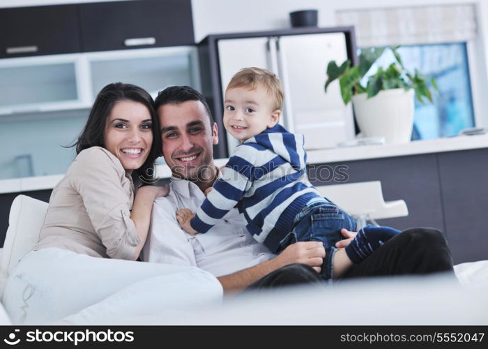 happy young family have fun and relaxing at new home with bright furniture