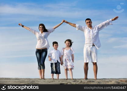 happy young family have fun on beachand showing home sign with conncected hands while protecting childrens