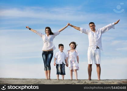 happy young family have fun on beachand showing home sign with conncected hands while protecting childrens