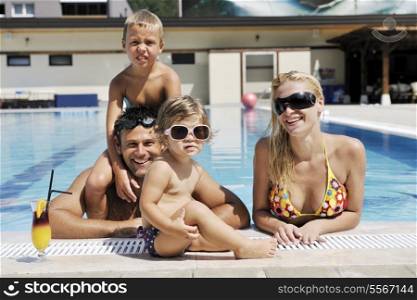 happy young family have fun on swimming pool at summer vacation