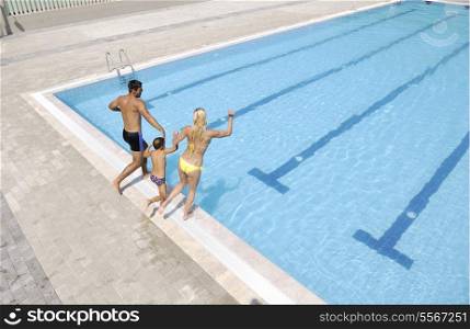happy young family have fun on swimming pool at summer vacation