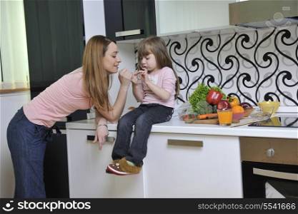 happy young family have lunch time with fresh fruits and vegetable food in bright kitchen