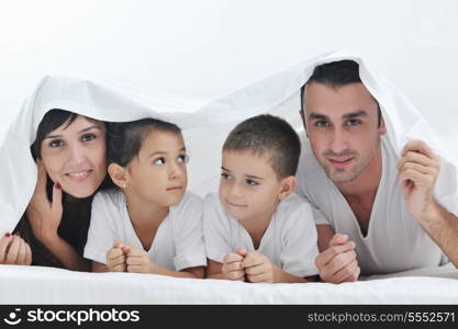 happy young Family in their bedroom have fun and play in bed