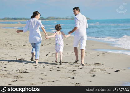 happy young family in white clothing have fun at vacations on beautiful beach