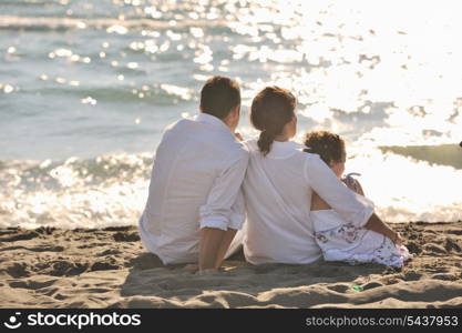 happy young family in white clothing have fun at vacations on beautiful beach