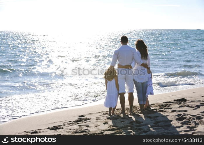 happy young family in white clothing have fun at vacations on beautiful beach